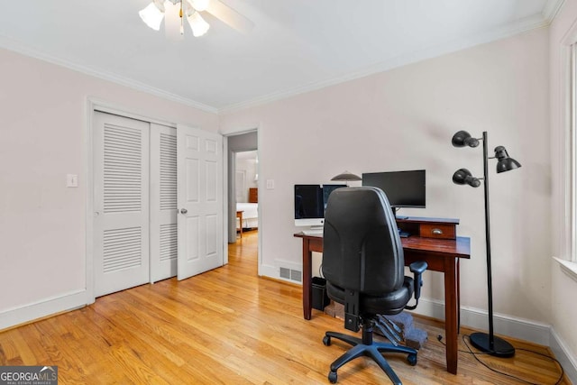 office featuring light hardwood / wood-style floors, ceiling fan, and ornamental molding