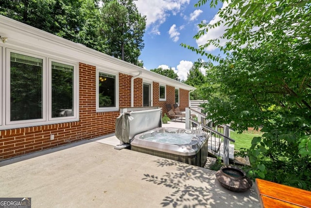 view of patio featuring a covered hot tub