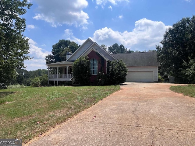 view of front of home featuring a garage, covered porch, and a front lawn