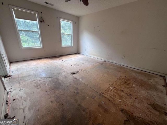 spare room with ceiling fan and a textured ceiling