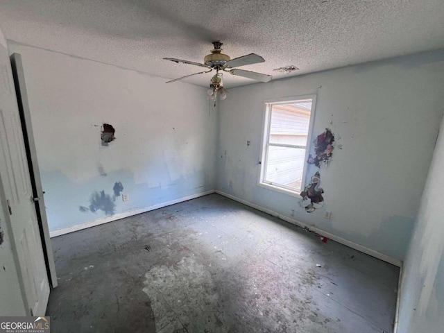 spare room with ceiling fan and a textured ceiling