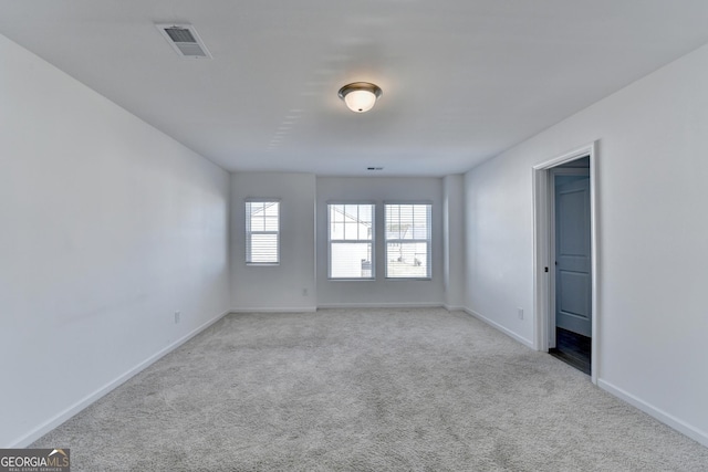 empty room with light colored carpet