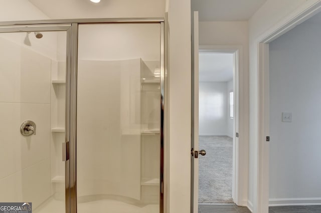 bathroom with a shower with door