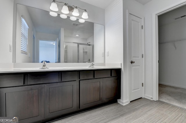 bathroom with vanity and a shower with shower door