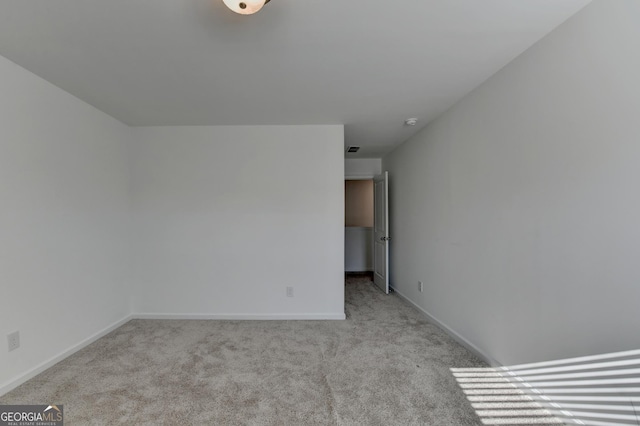 unfurnished room with light colored carpet