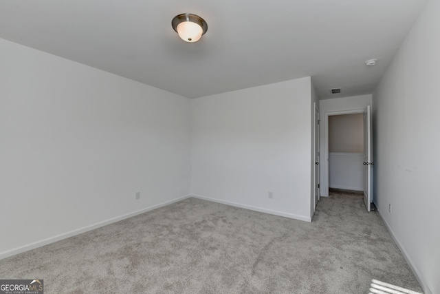 unfurnished room with light colored carpet