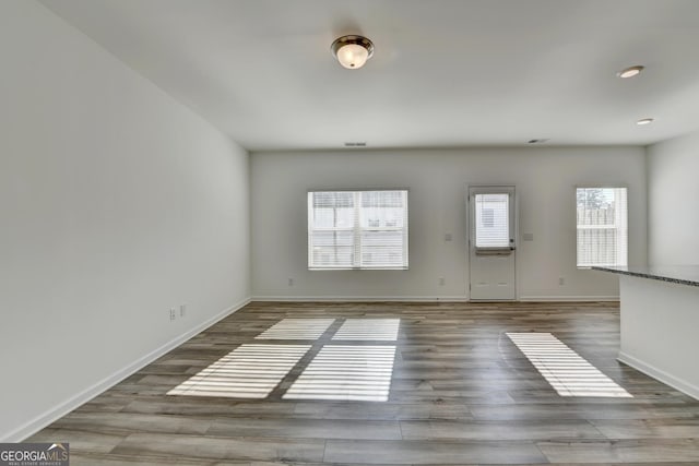 unfurnished room with hardwood / wood-style floors