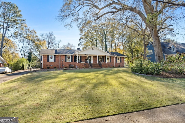 ranch-style house featuring a porch and a front lawn