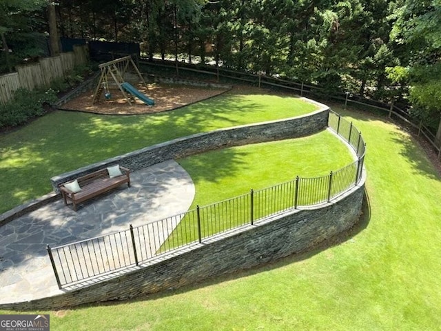 view of community with a playground and a lawn