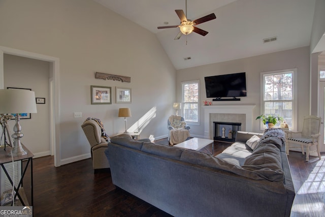 living room with a fireplace, dark hardwood / wood-style flooring, high vaulted ceiling, and ceiling fan