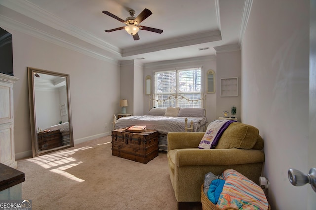 carpeted bedroom featuring ceiling fan, a raised ceiling, and crown molding