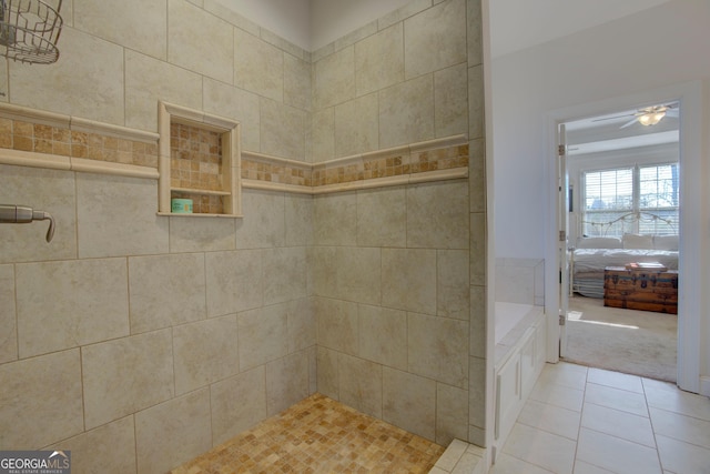 bathroom with tile patterned floors, a tile shower, and tile walls