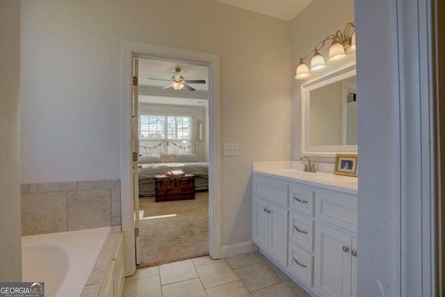 bathroom featuring tile patterned flooring, ceiling fan, vanity, and tiled bath