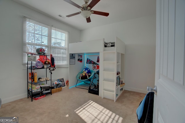 bedroom featuring light carpet and ceiling fan