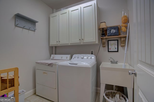 clothes washing area featuring cabinets, independent washer and dryer, and light tile patterned floors