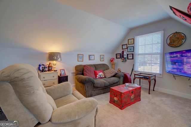 carpeted living room featuring vaulted ceiling