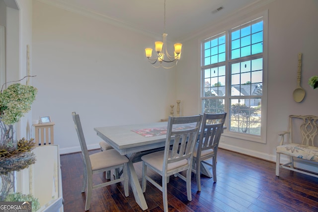 dining room featuring dark hardwood / wood-style flooring, crown molding, and an inviting chandelier