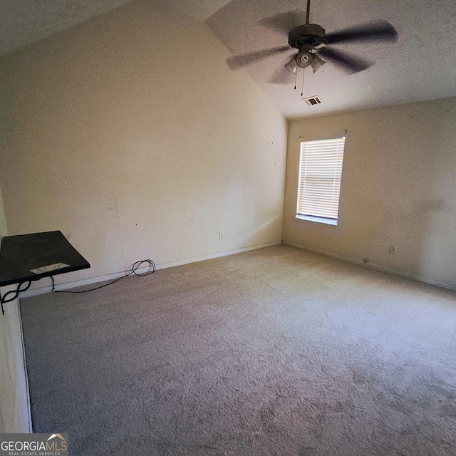 unfurnished room with carpet, vaulted ceiling, and ceiling fan