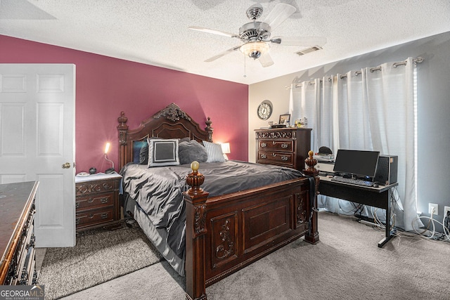 carpeted bedroom with ceiling fan and a textured ceiling