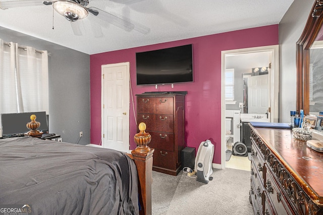 bedroom featuring ceiling fan, light colored carpet, and a textured ceiling