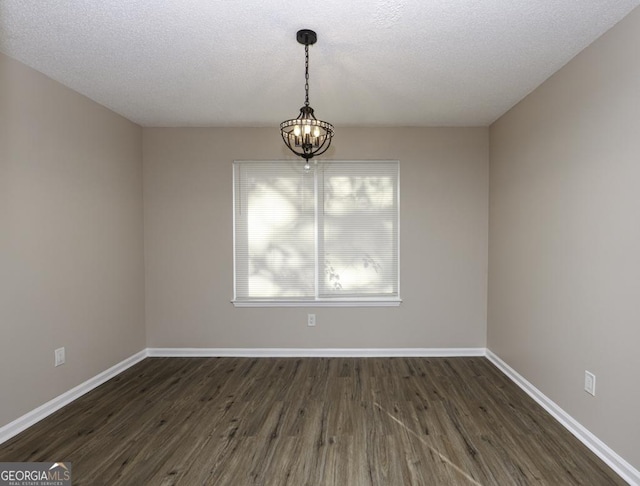 unfurnished dining area with baseboards, a chandelier, and dark wood-style flooring