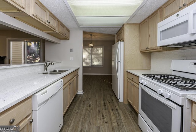 kitchen with white appliances, sink, light brown cabinets, dark hardwood / wood-style floors, and hanging light fixtures