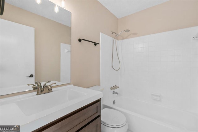 full bathroom featuring vanity, tiled shower / bath, and toilet