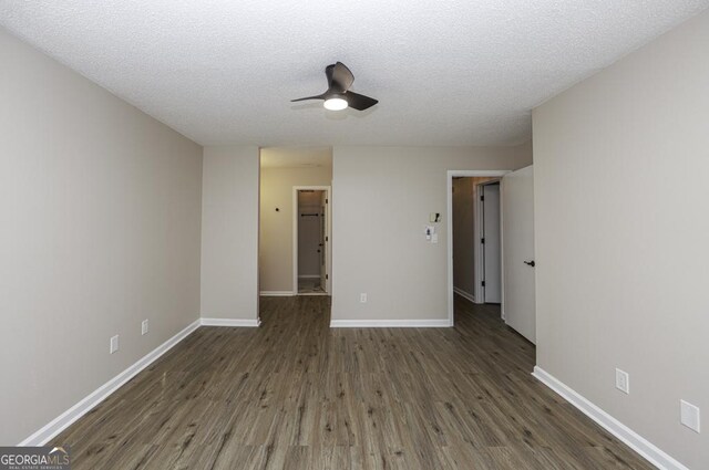 unfurnished room with dark hardwood / wood-style floors, ceiling fan, and a textured ceiling