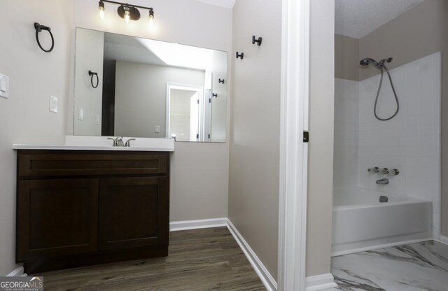 bathroom featuring vanity,  shower combination, and wood-type flooring