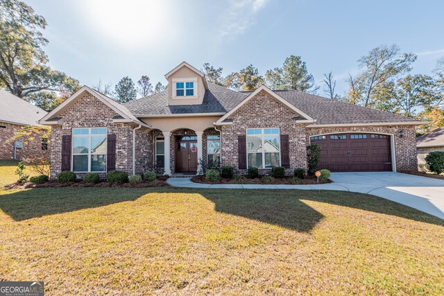 view of front facade with a garage and a front lawn