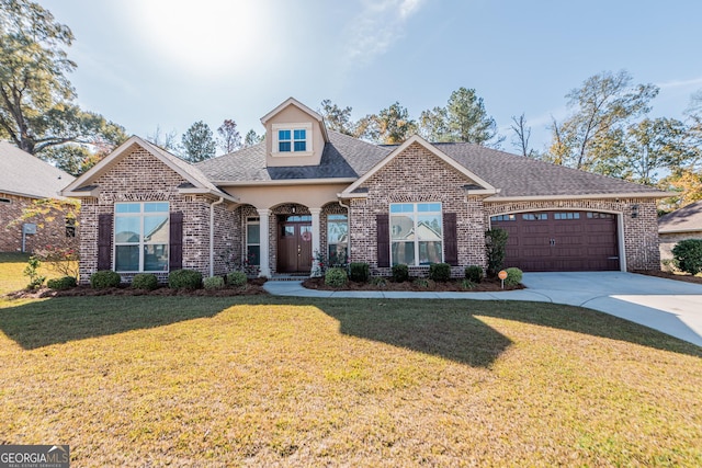 view of front facade with a garage and a front lawn