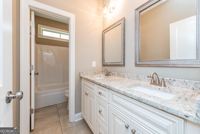 full bathroom featuring vanity, toilet, tile patterned flooring, and shower / bathing tub combination