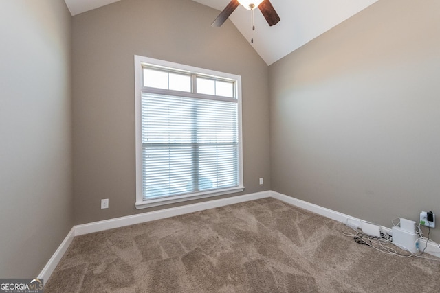 carpeted spare room with ceiling fan and lofted ceiling