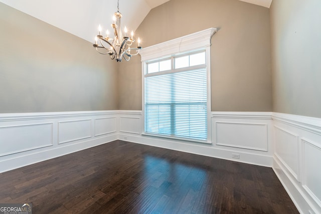 unfurnished room with vaulted ceiling, dark wood-type flooring, and a chandelier