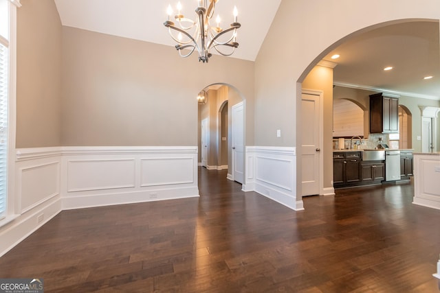 unfurnished dining area with lofted ceiling, dark hardwood / wood-style flooring, and sink