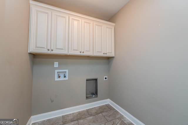 laundry room with electric dryer hookup, washer hookup, and cabinets