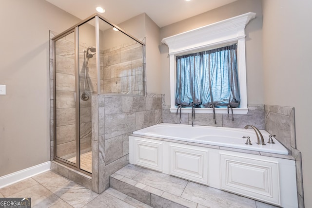 bathroom featuring independent shower and bath