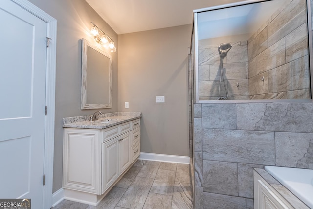 bathroom featuring vanity and a tile shower