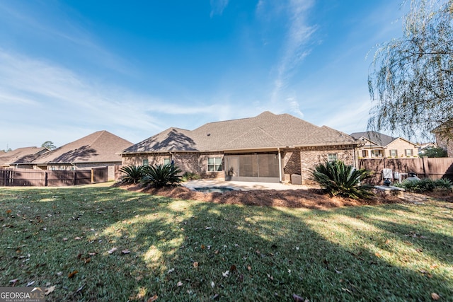 back of property with a patio and a lawn