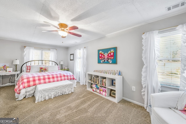 carpeted bedroom with ceiling fan and a textured ceiling