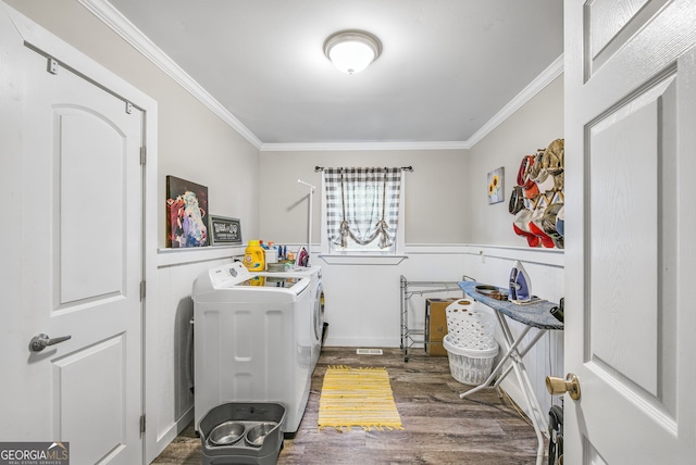 laundry area featuring dark hardwood / wood-style floors, separate washer and dryer, and crown molding