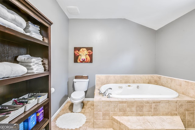 bathroom featuring tile patterned flooring, tiled bath, toilet, and lofted ceiling