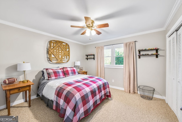 carpeted bedroom with ceiling fan, ornamental molding, and a closet