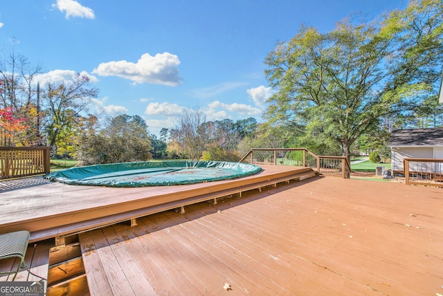 wooden terrace featuring a jacuzzi