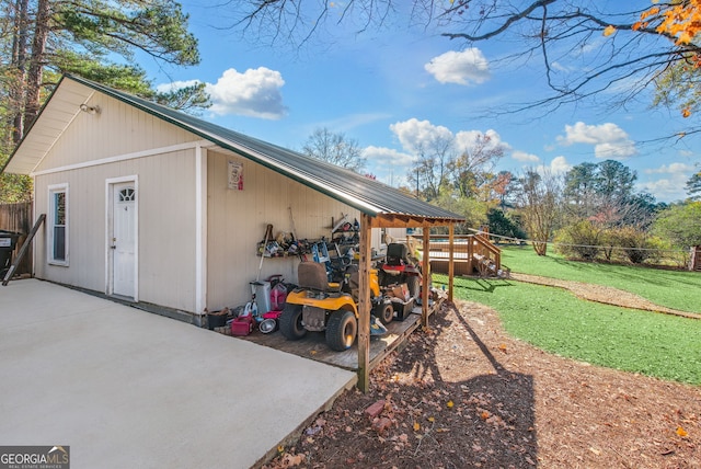 view of outbuilding featuring a lawn