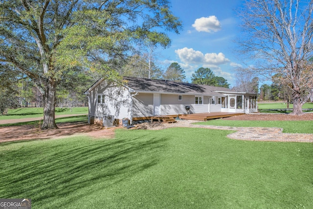 exterior space featuring a sunroom, a deck, and a front yard