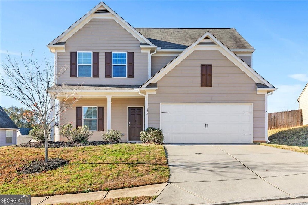 view of front of property featuring a garage and a front yard