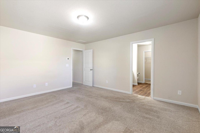 empty room featuring light colored carpet