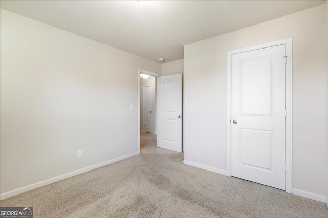 unfurnished bedroom with light colored carpet