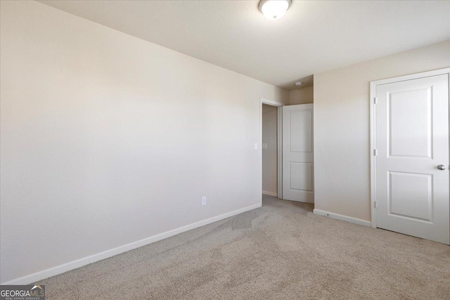 unfurnished bedroom featuring a closet and carpet